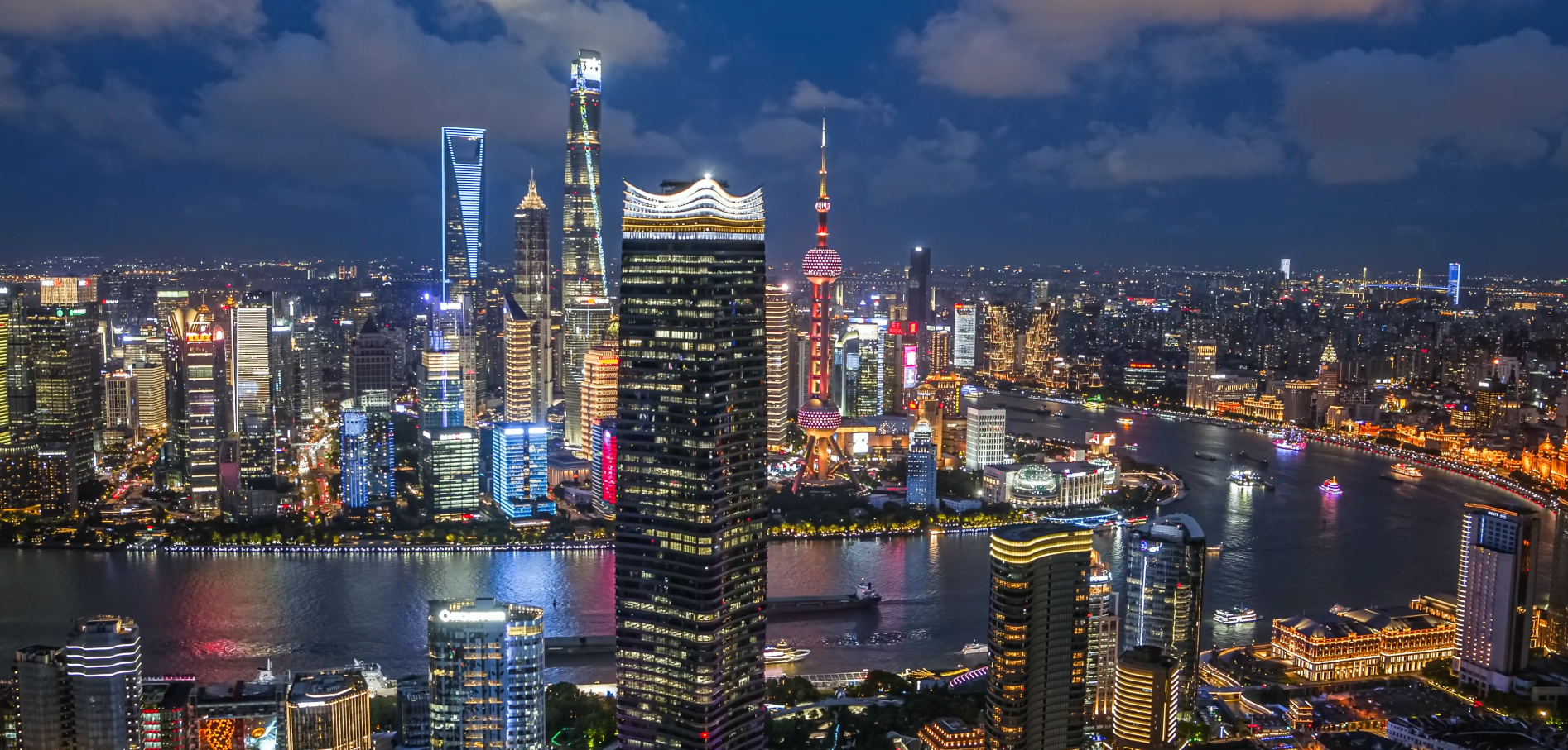 Shanghai skyline at night with illuminated skyscrapers along the Huangpu River